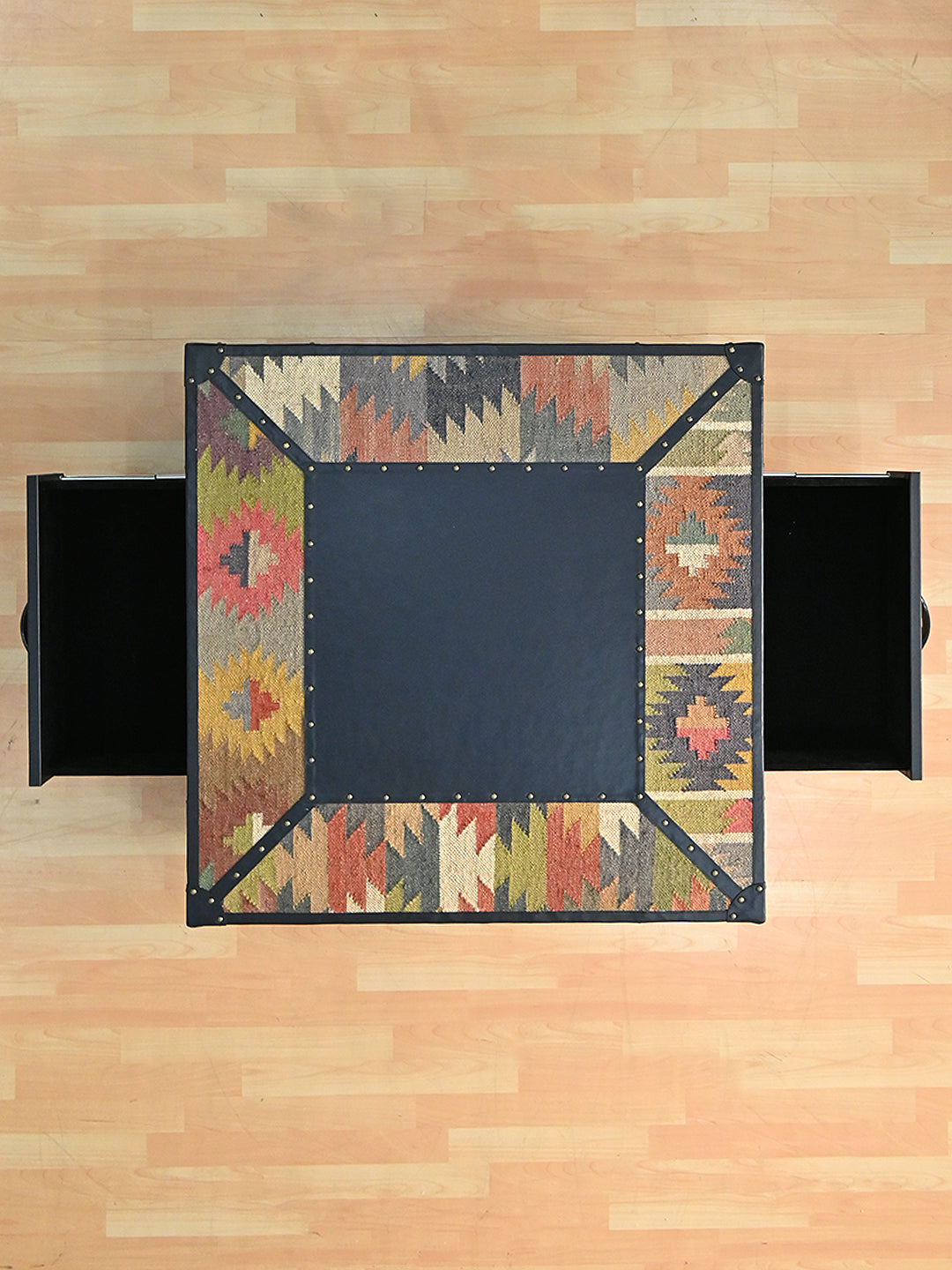 Overhead view of the Mehrangarh coffee table with both drawers extended, Art Avenue kilim and Onyx leather, made to order