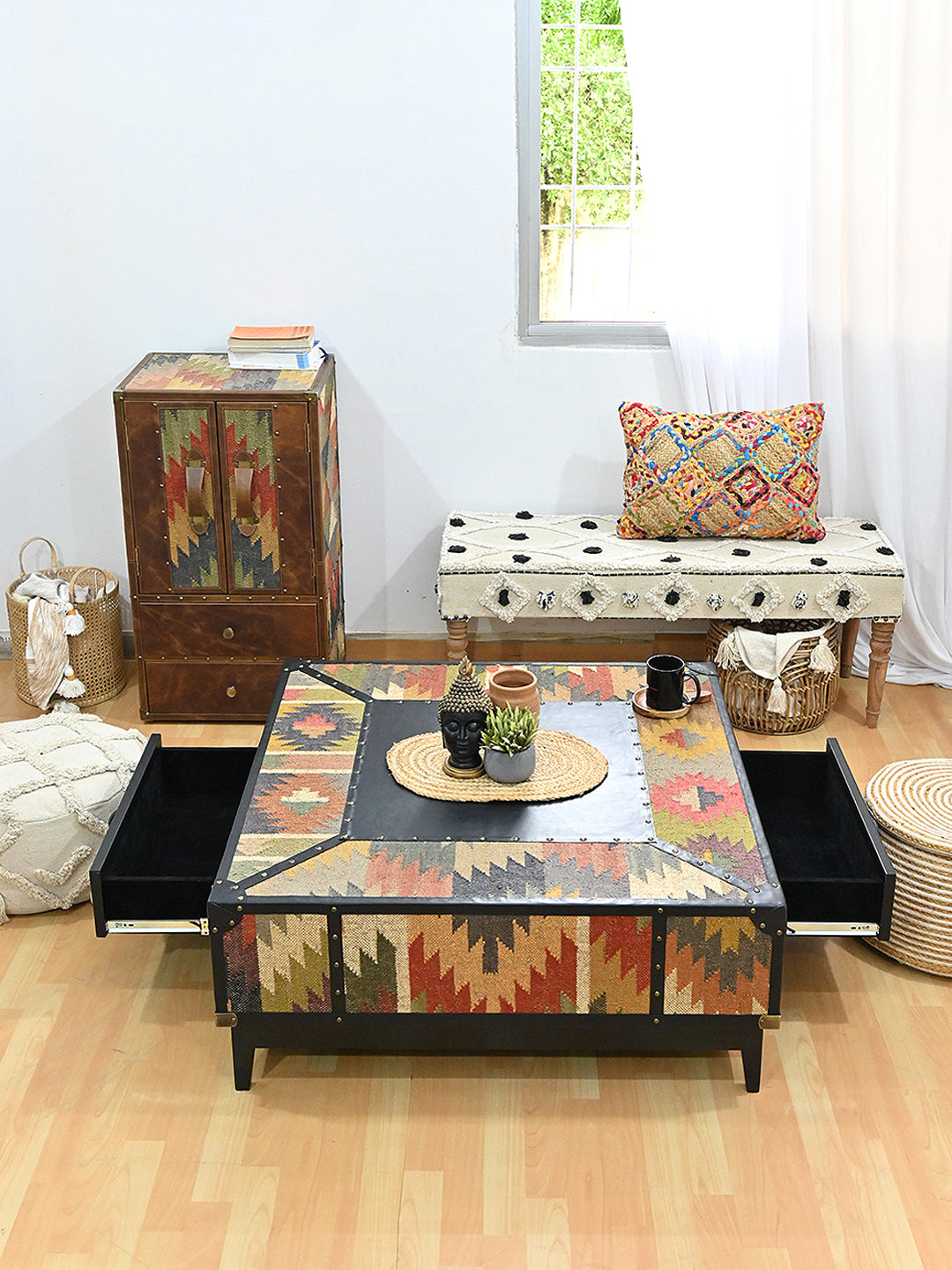 Mehrangarh coffee table in a styled room with both drawers open, black Onyx leather and vintage kilim, Art Avenue