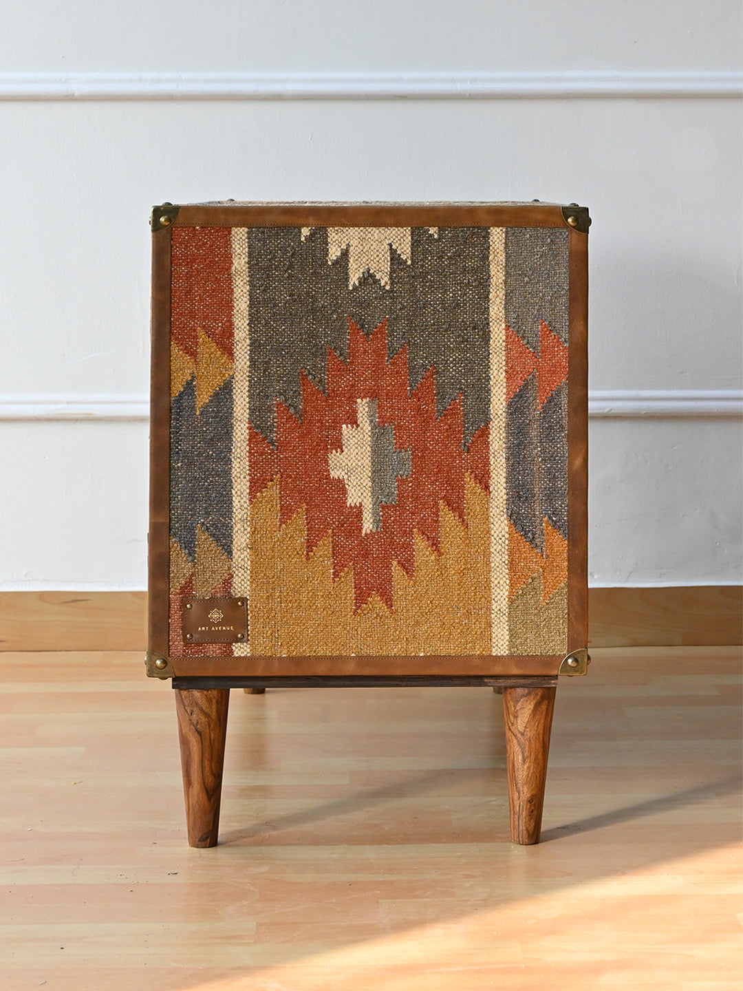 Side of the Kanota sideboard by Art Avenue, a single vintage kilim panel framed in leather with brass corner caps