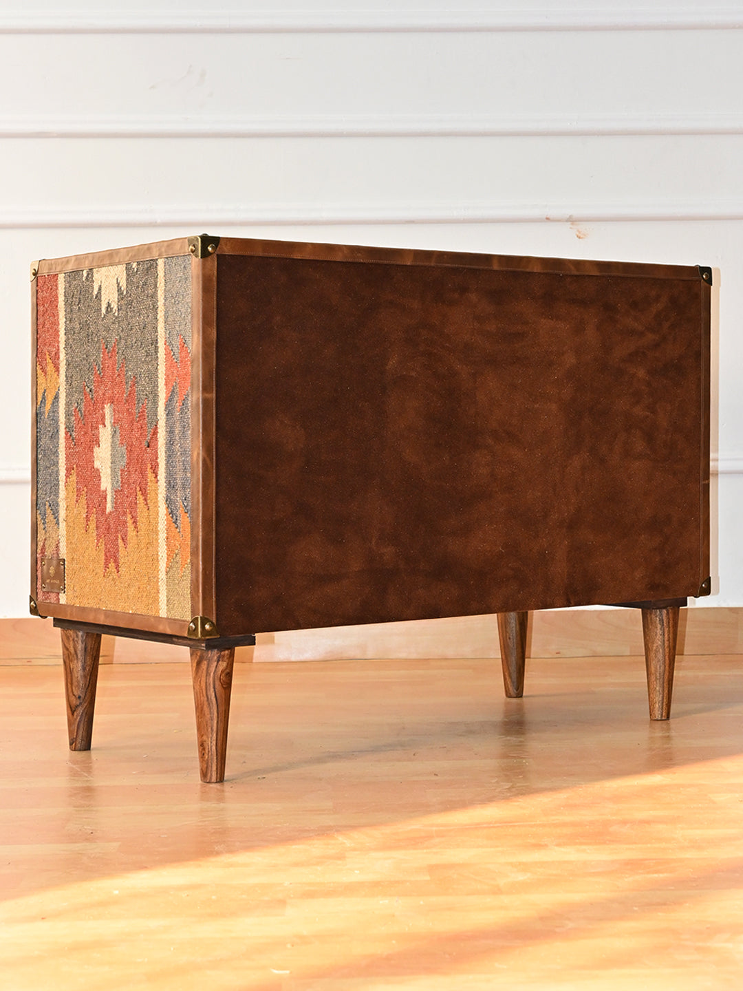Back of the Kanota sideboard by Art Avenue, finished in brown nap and bound in leather
