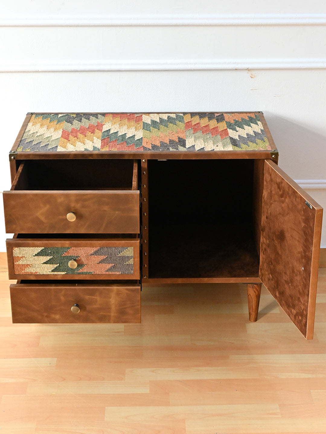 Kanota sideboard by Art Avenue open from above, three drawers and the open cupboard beneath the kilim top