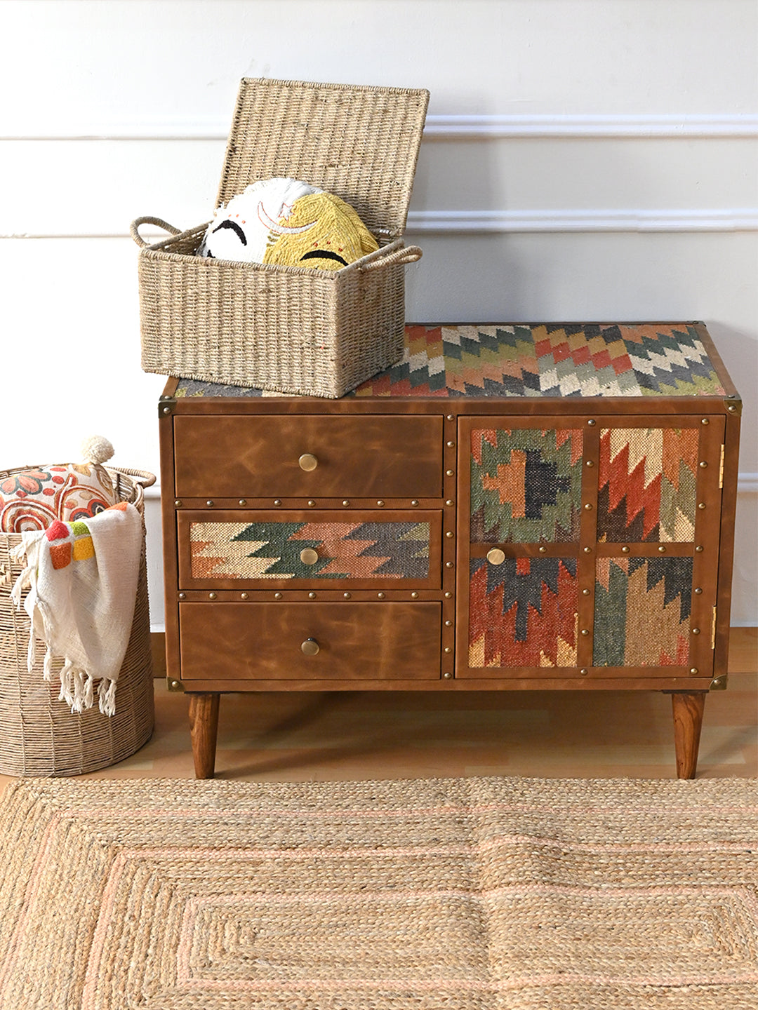 Kanota sideboard by Art Avenue styled with an open woven basket on its kilim top and a jute rug