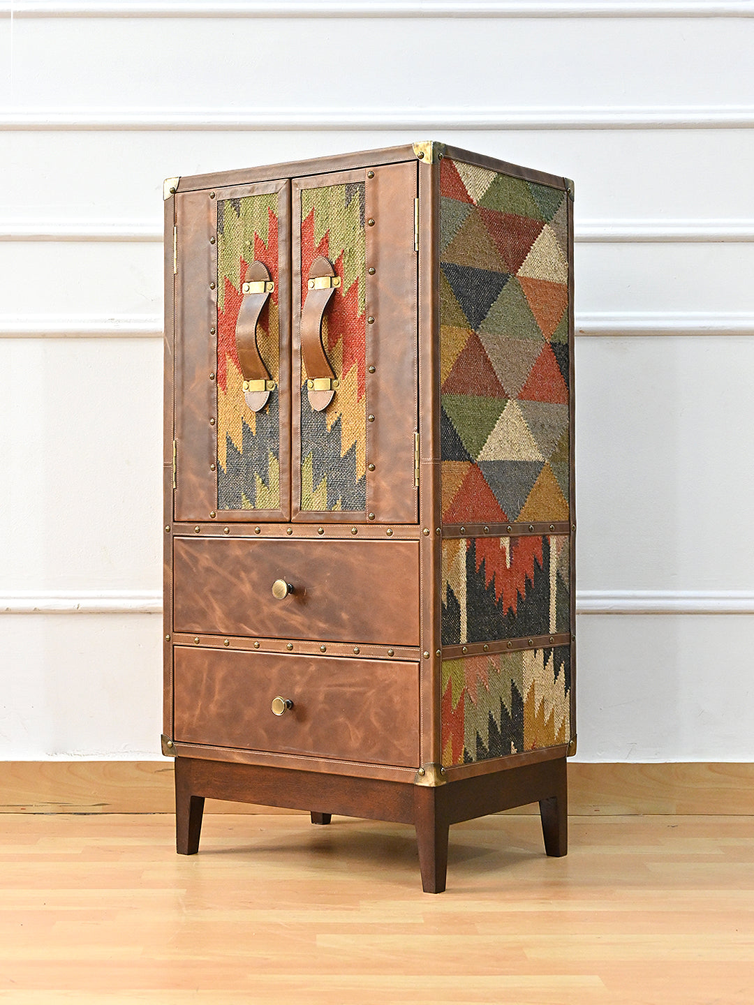 Shalimar cabinet three-quarter view showing the full-height kilim flank and studded leather front — Art Avenue