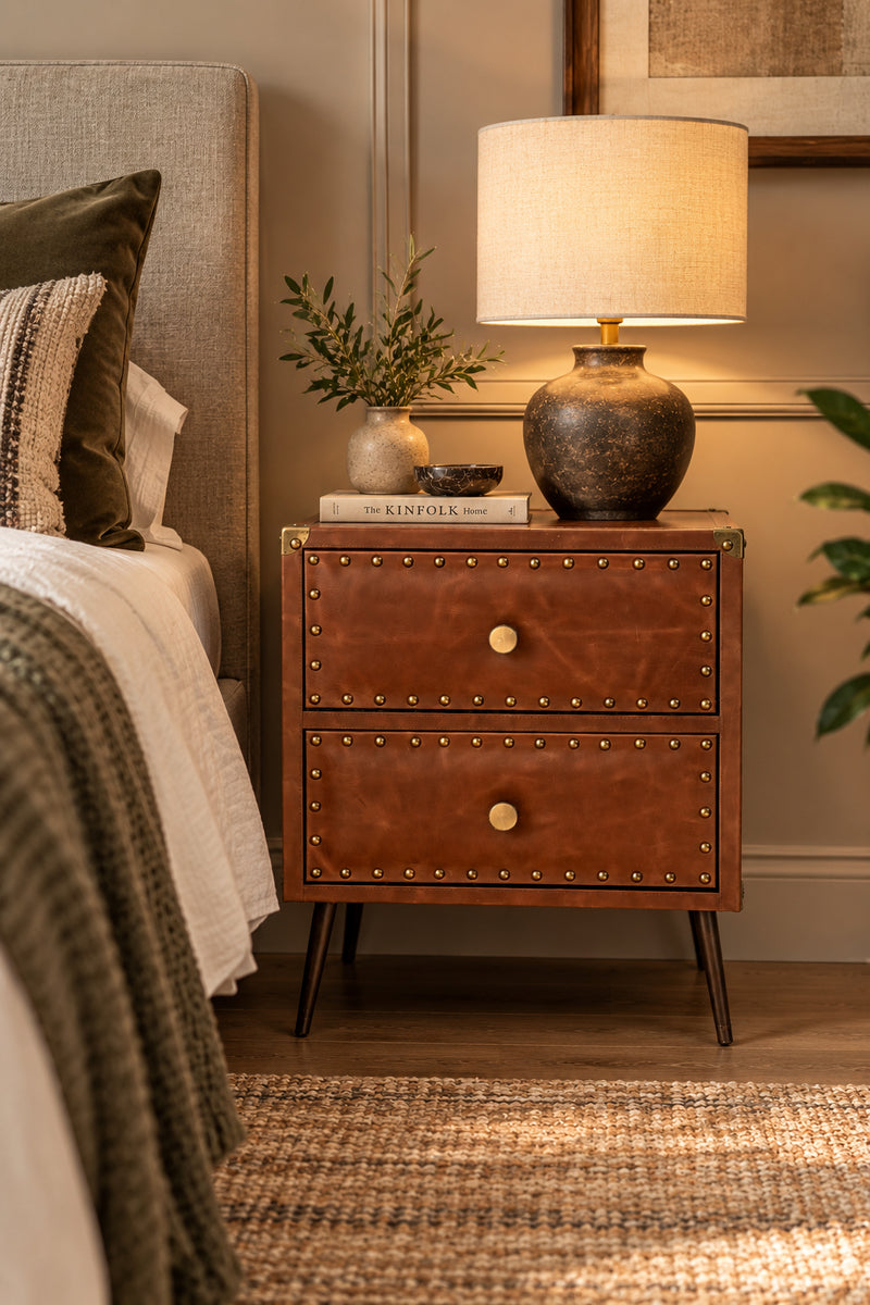 Kishangarh studded leather bedside table in brown leather beside a bed, with a table lamp, Art Avenue, made to order