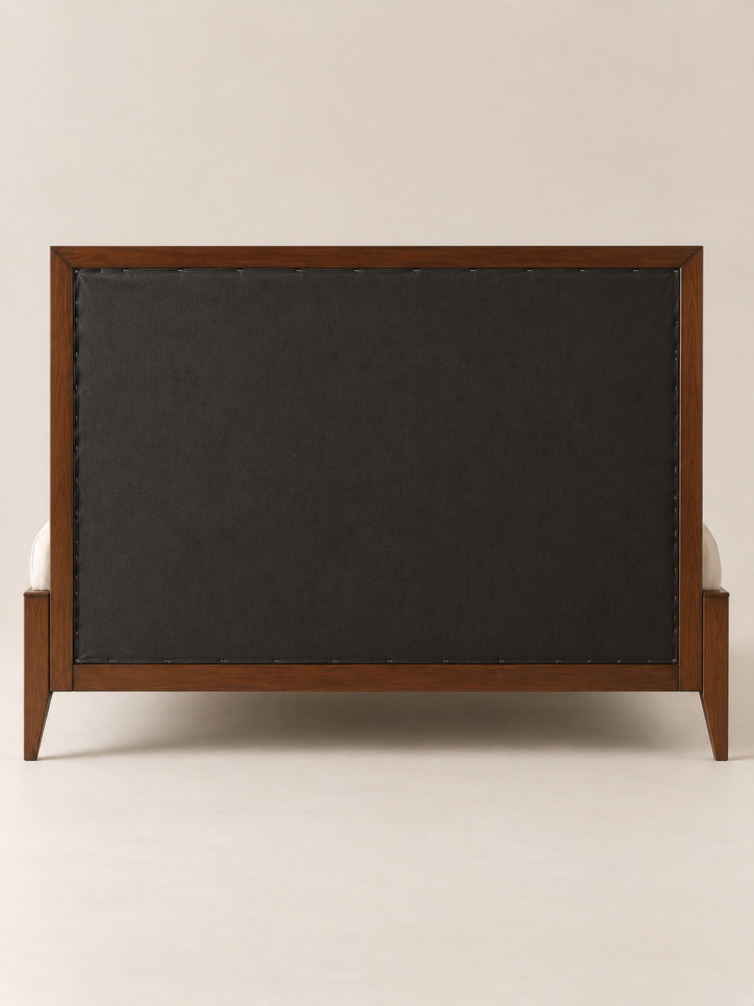 Back of the Landour Tufted Upholstered Bed headboard, closed with dust cloth inside the Walnut frame, on square tapered legs. Art Avenue, made to order.