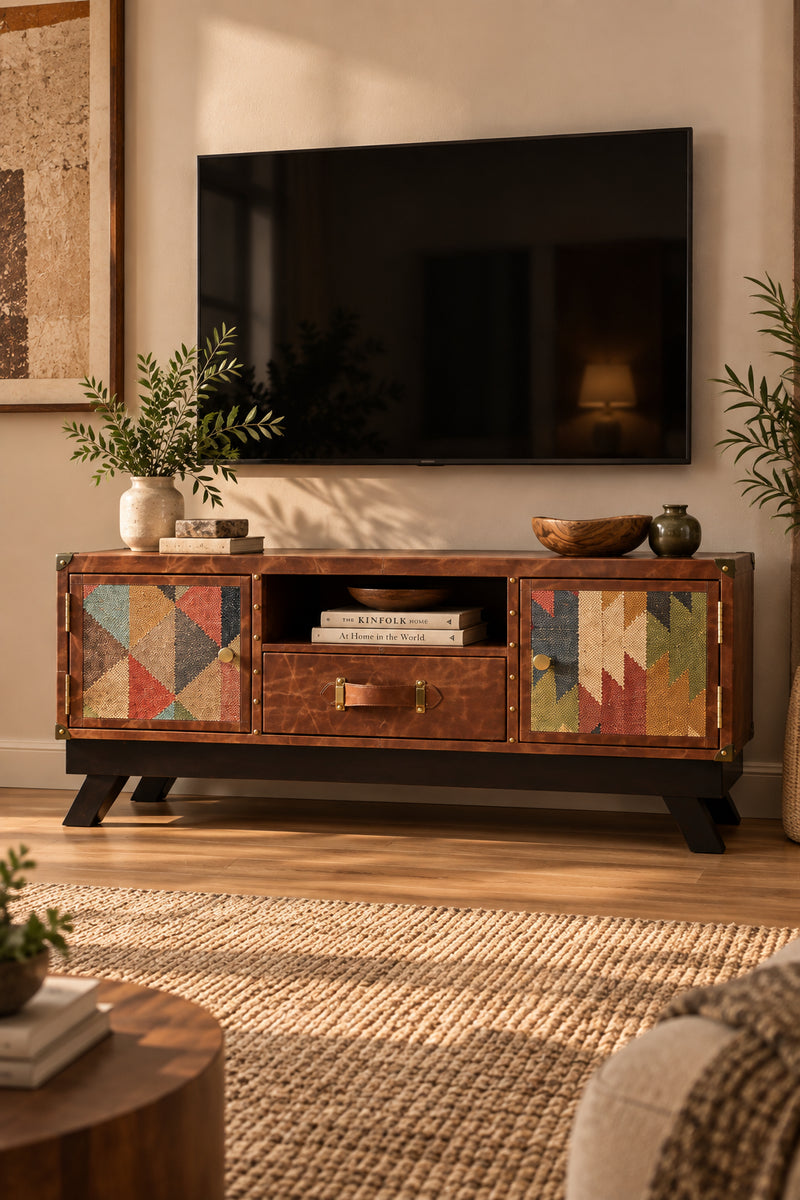 Karauli kilim and leather TV unit styled in a warm living room beneath a wall-mounted television